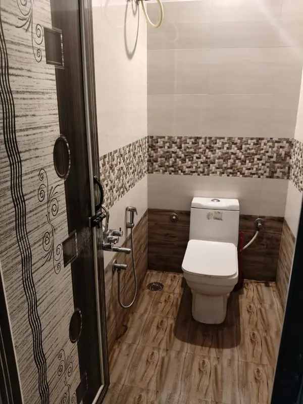 1 BHK bathroom with shower and western toilet