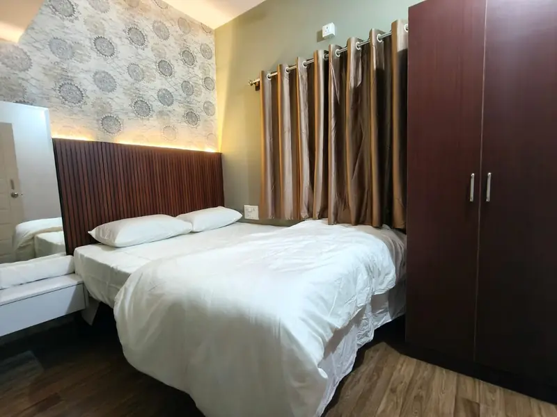1 BHK bedroom with wardrobe and curtains