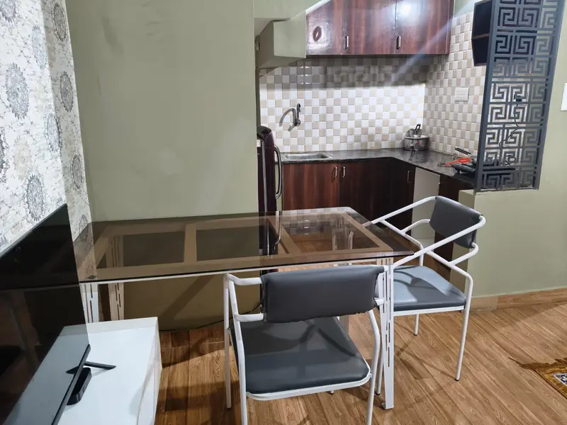 1 BHK dining table beside the kitchen