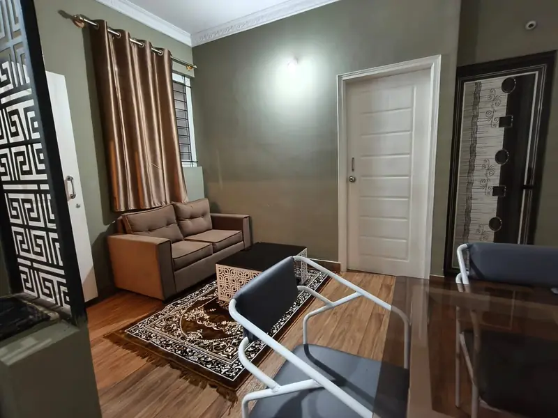 1 BHK living area with sofa and glass dining table