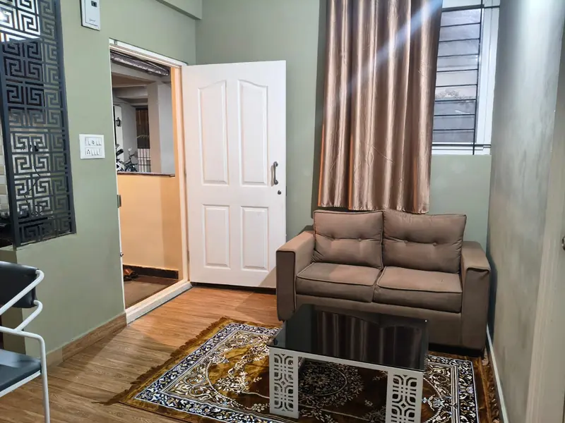 1 BHK living room with sofa and centre table