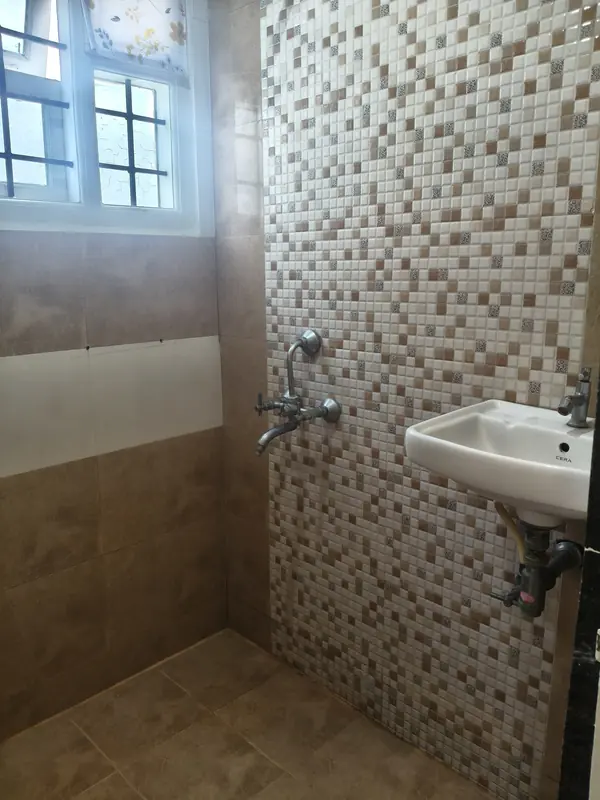 2 BHK bathroom with shower and wash basin