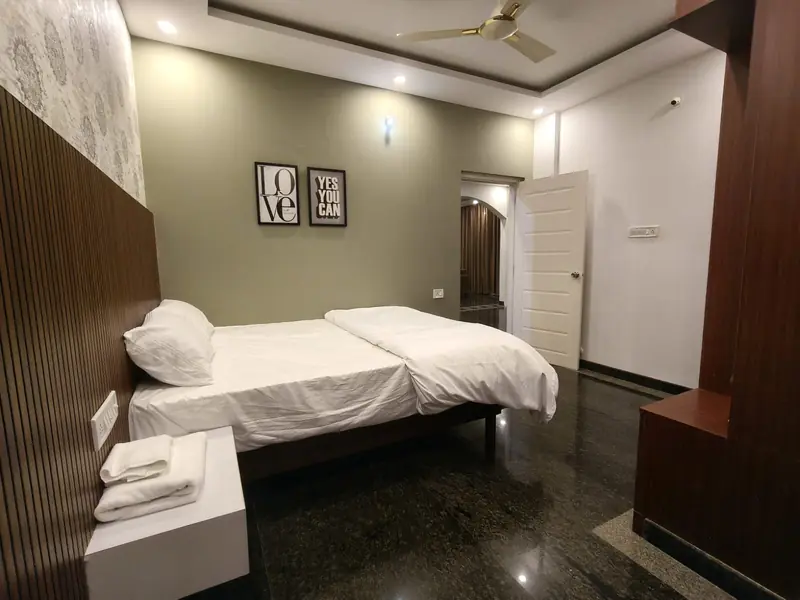 2 BHK bedroom with fresh towels and linen