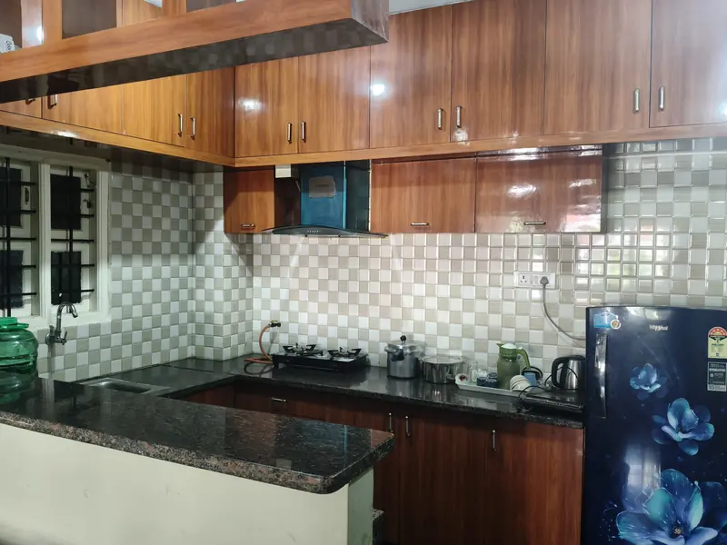 2 BHK modular kitchen with gas stove and refrigerator