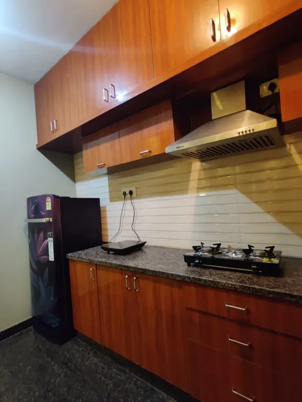Kitchen with chimney, gas hob and refrigerator