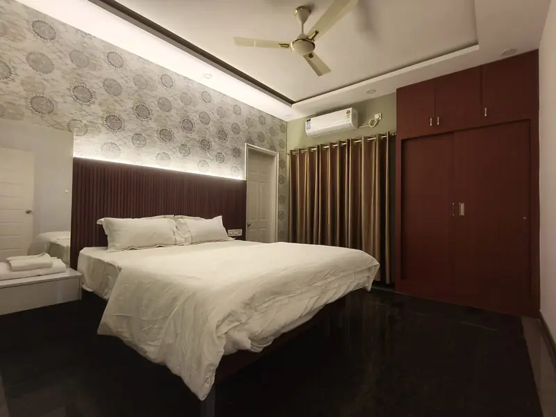 Air-conditioned 2 BHK bedroom with backlit headboard