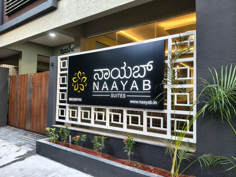 Naayab Suites name board at the building entrance